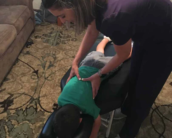a young boy having a chiropractic care